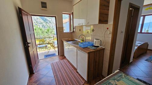 a kitchen with a sink and a counter top at B & M Apartments in Kotor