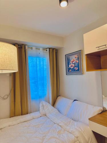 Ένα ή περισσότερα κρεβάτια σε δωμάτιο στο 2 Bed Room Cozy Condo Cebu