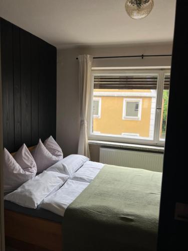 a bedroom with a large bed with a window at Wohnung Albrecht Nummer 4 in Spalt
