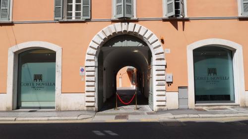 an entrance to a building with two arched windows at Corte Novella Hotel & Residence in Brescia