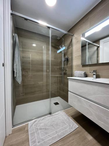 a bathroom with a glass shower and a sink at Josemaenea 2 in Pamplona