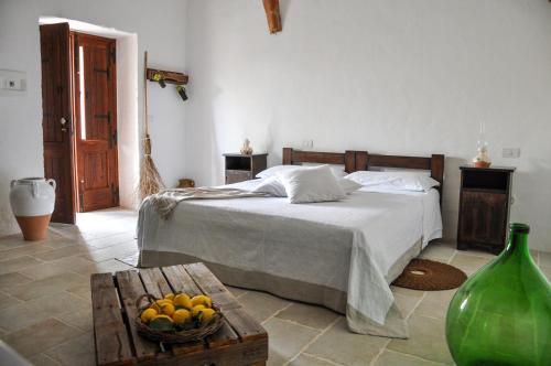 a bedroom with a bed and a bowl of fruit at Masseria Uccio in Tricase