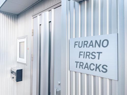 a sign on a building that reads farma first tracks at Furano First Tracks - 5mins to ski field in Furano