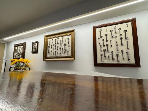 a room with three framed pictures on a wall at Affittacamere Il Cuore Verde in Norcia