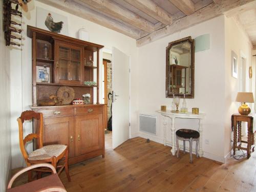 a living room with a table and a mirror at Very nice cottage with studio on a domain with heated pool in Roussines