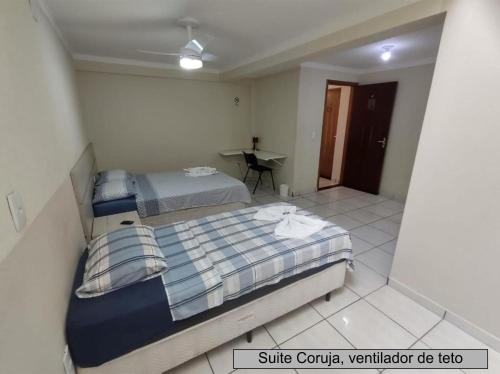 a bedroom with a bed and a desk in it at Pousada Happy Inn in Campinas