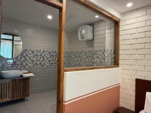 a bathroom with a sink and a mirror at The Dune Escape in Hundar