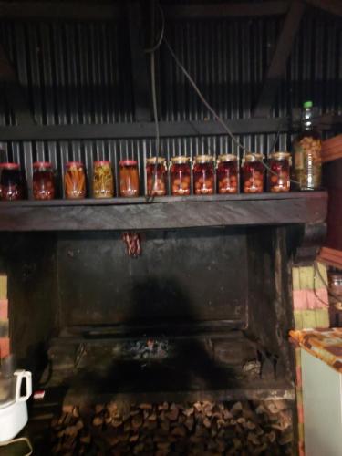a fireplace with a bunch of cups on top of it at Auberge grand bassin chez Kevin in Le Tampon