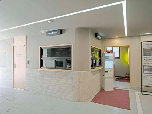 an entrance to an office building with a microwave at 창원 호텔 레오 팔용점 in Changwon