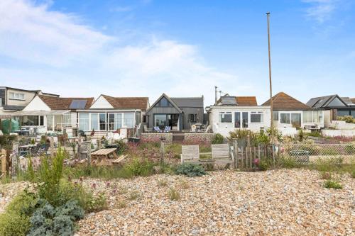 a house with a garden in front of it at Seashells-Stylish Coastal Living in Pevensey