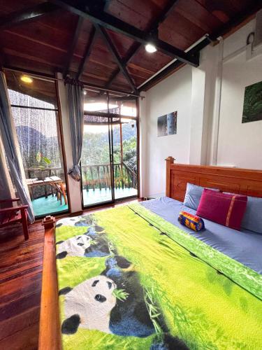 a bedroom with a bed with a toy train on it at Ravana Falls Resort in Ella