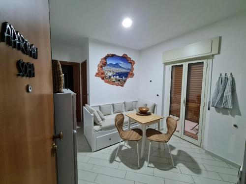 a living room with a table and a couch at Apartman SOFIA - close to the railway station in Scalea