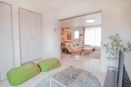 a living room with a couch and a table at Furano First Tracks - 5mins to ski field in Furano