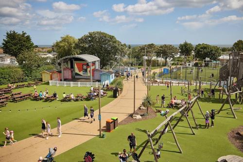 a group of people in a park with a playground at BEACH SIDE CARAVAN - haven - Caister on sea in Caister-on-Sea