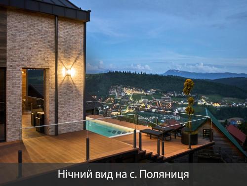 a house with a balcony with a view of a city at Villas Fomich in Bukovel