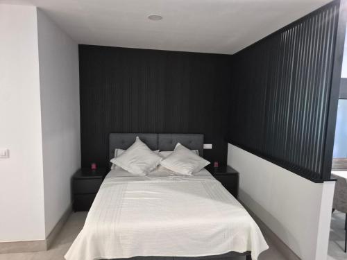 En eller flere senge i et værelse på Apartamento Gold Hilados