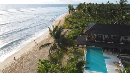 an aerial view of a beach with a resort at Yapak Beach Villas in San Isidro