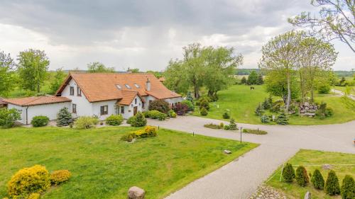 an aerial view of a house with a yard at Zasypane Mazury, Sun & Snow in Orło