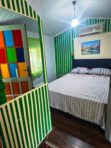 a bedroom with a bed and a colorful door at Side Tuana Garden Home in Side