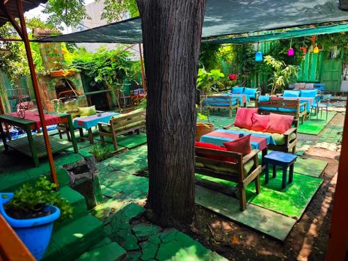 a patio with tables and chairs and a tree at Side Tuana Garden Home in Side