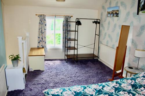 a bedroom with a bed and a window at Severn Up in Newtown