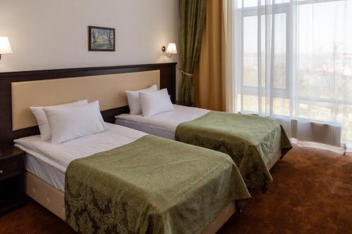 Кровать или кровати в номере Stadium Park Hotel