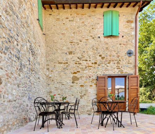 a patio with tables and chairs in front of a building at Villa Francesca in Castel Ritaldi