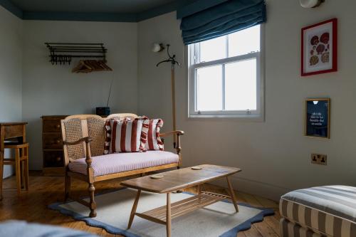 a living room with a chair and a window at The London & Paris Hotel in Folkestone