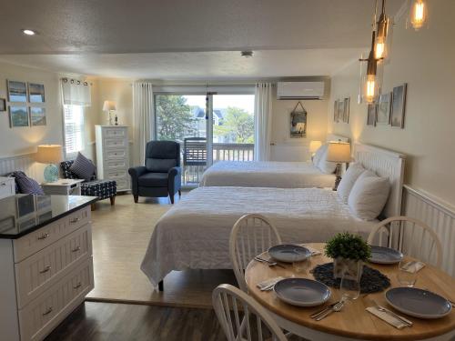 a bedroom with a bed and a table with plates on it at The Braemar Condominium in North Truro