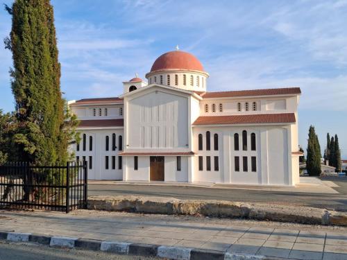 a large white building with a red dome on it at Stunning Sea & Sky View- 3BR, Pool ,Amazing Balcony in Trimitusa