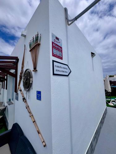 a white building with signs on the side of it at Apartamentos y Lofts Makana in Playa Blanca