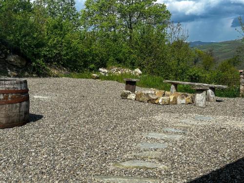 a picnic table and logs and a bench at Holiday appartment Casa del Cervo in Sestola