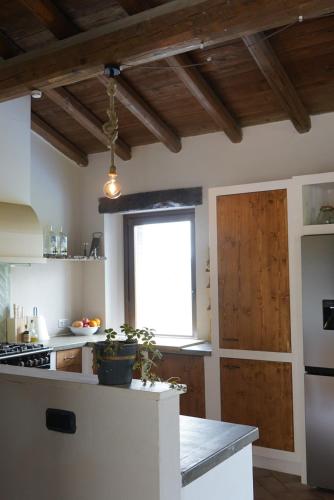 a kitchen with a white counter and a window at Holiday appartment Casa del Cervo in Sestola