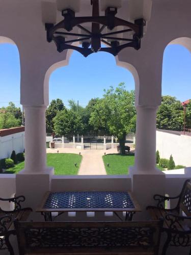 a bench on a porch with a view of a park at Conac Bistreanu in Eforie Sud