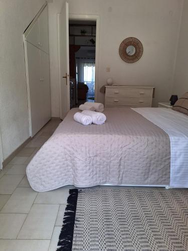 a bedroom with a bed with towels on it at Salt & Pine in Kallithea Halkidikis