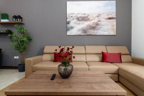 a living room with a couch and a table at BLVD - Spacious Fully Equipped Luxury Residences - Dubai - JVC in Dubai