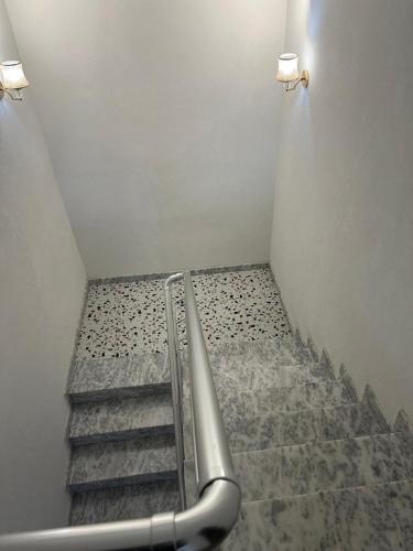 a staircase in a room with a metal railing at Guesthouse NA in Durrës