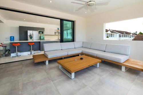 a living room with a couch and a coffee table at Stella Aparthotel, Las Terrenas in Las Terrenas