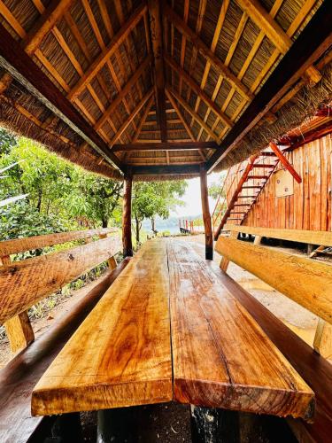 a wooden table in the middle of a building at Kasana Lake House in Isunga