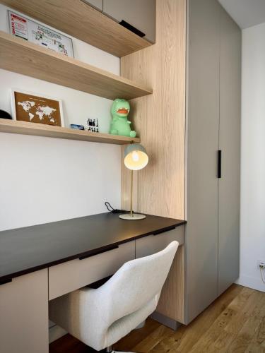 un bureau avec un bureau et une chaise blanche dans l'établissement Studio cosy et calme Paris 17 Batignolles, à Paris
