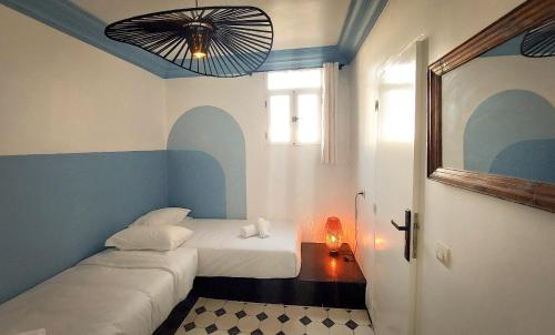 a small room with two beds and a window at Little Wing in Diabat