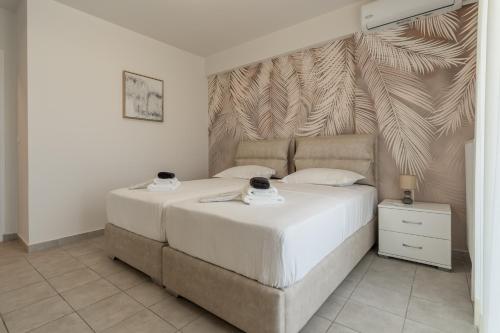 a bedroom with a large bed with white sheets at Horizon Luxury Living Breathtaking Seaview Minutes from the Airport in Artemida