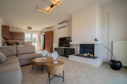 a living room with a couch and a fireplace at Horizon Luxury Living Breathtaking Seaview Minutes from the Airport in Artemida