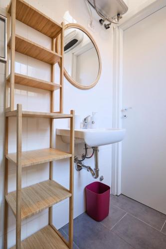 a bathroom with a sink and a mirror at Il Loft nella corte in Cormano