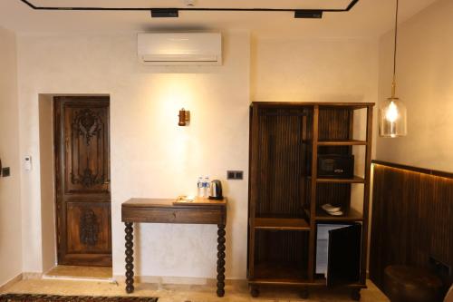 a room with a wooden table and a book shelf at Erdu Cappadocia Stone House in Avanos