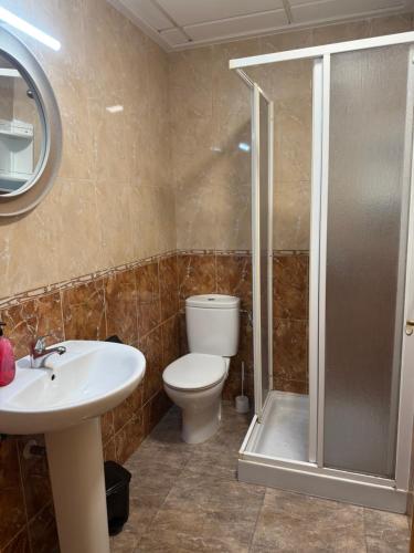 a bathroom with a toilet and a sink and a shower at Apartamento terramarzarron in Mazarrón