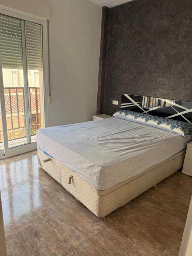 a bedroom with a large bed in a room at Apartamento terramarzarron in Mazarrón