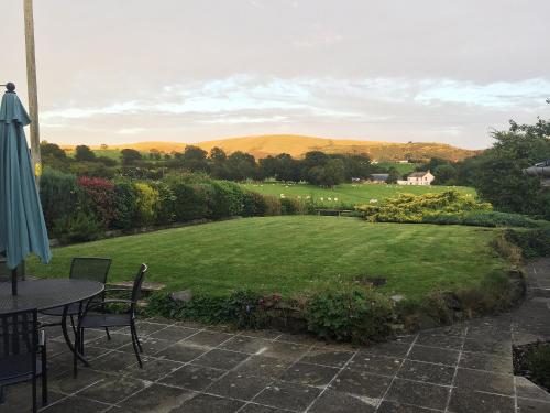 a view of a garden with a table and chairs at The Old Post Office in Myddfai