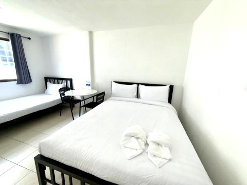 a bedroom with a bed with two white bows at Patong Canal Villa 210 in Patong Beach