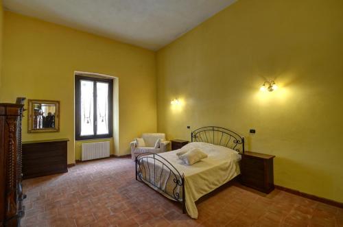 a bedroom with a bed and a mirror and a window at Palazzo Centro Alloggi Vacanza in Nizza Monferrato